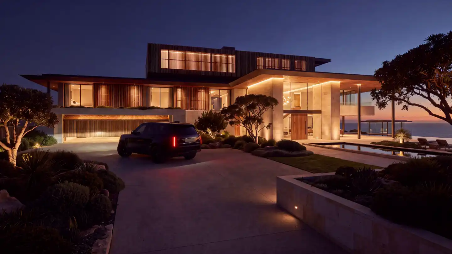 Coming home: a blacked-out SUV pulled up at the open, glowing garage at night.